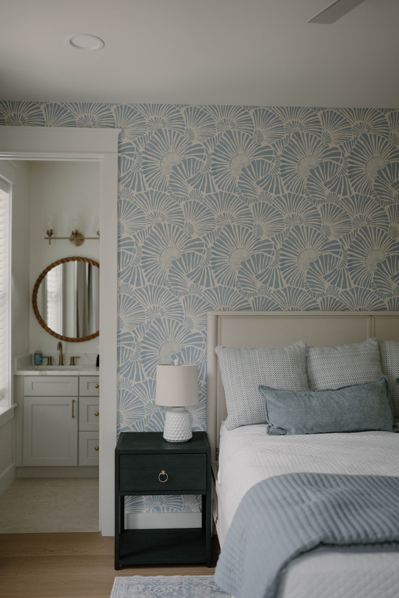 Coastal bedroom with shell-print wallpaper